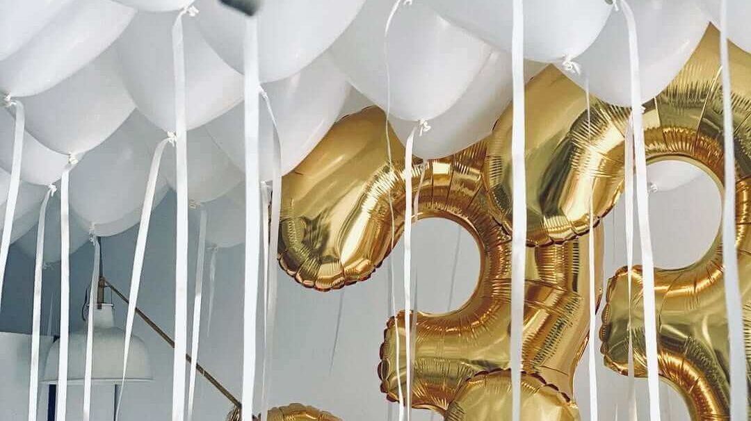 White ceiling balloons with Gold numerical balloons