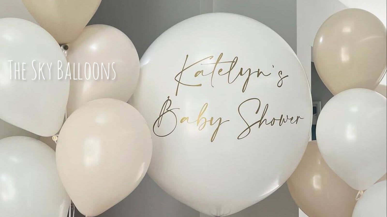 Personalized baby shower balloons in elegant cream and beige colors with custom Katelyn's Baby Shower message, delivered in Dubai
