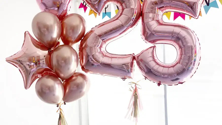 Rose gold balloons with number '25' for a 25th birthday celebration.