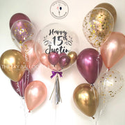 A festive arrangement of gold and pink balloons, creating a vibrant and celebratory atmosphere.