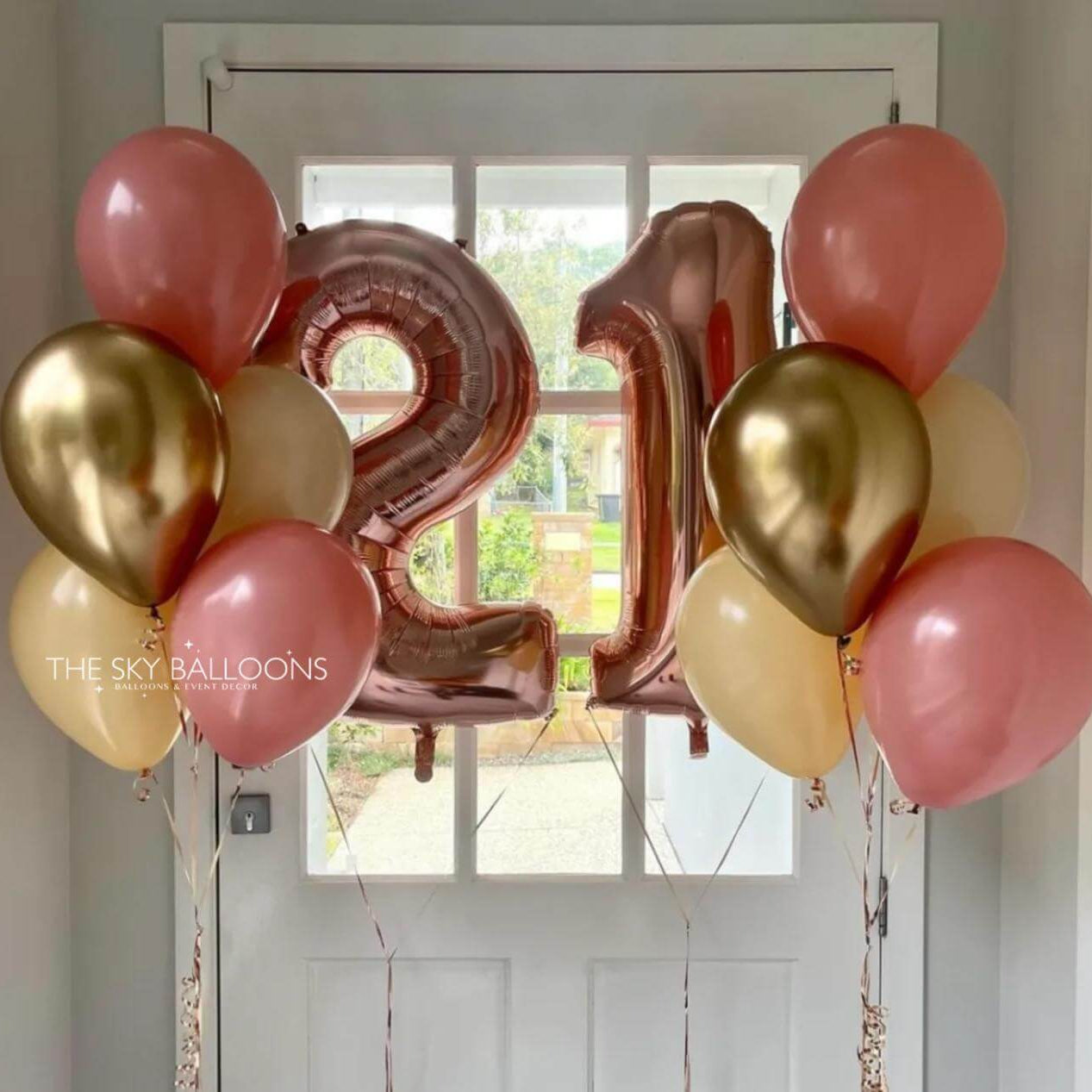 Balloons with number '21' in front of a door