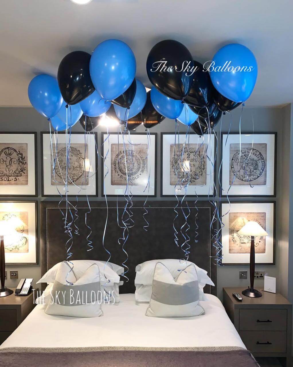 Black and blue ceiling balloon installation in fashionable party decor arrangement