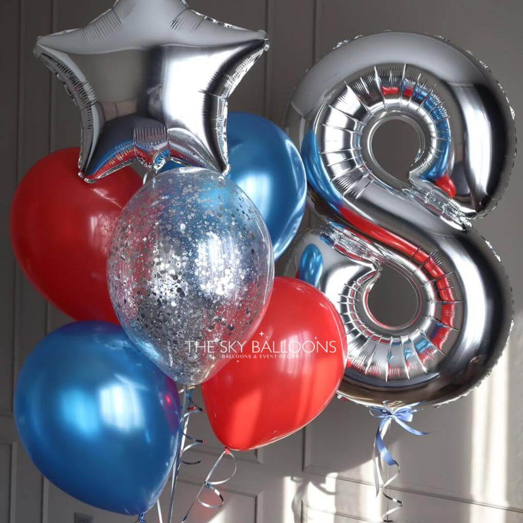 Bouquet of balloons including a silver star, number 8 balloon, red heart, and blue balloons against a neutral background.