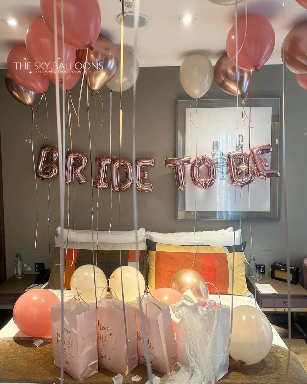 Decorative setup with 'BRIDE TO BE' balloons and balloons in a room.