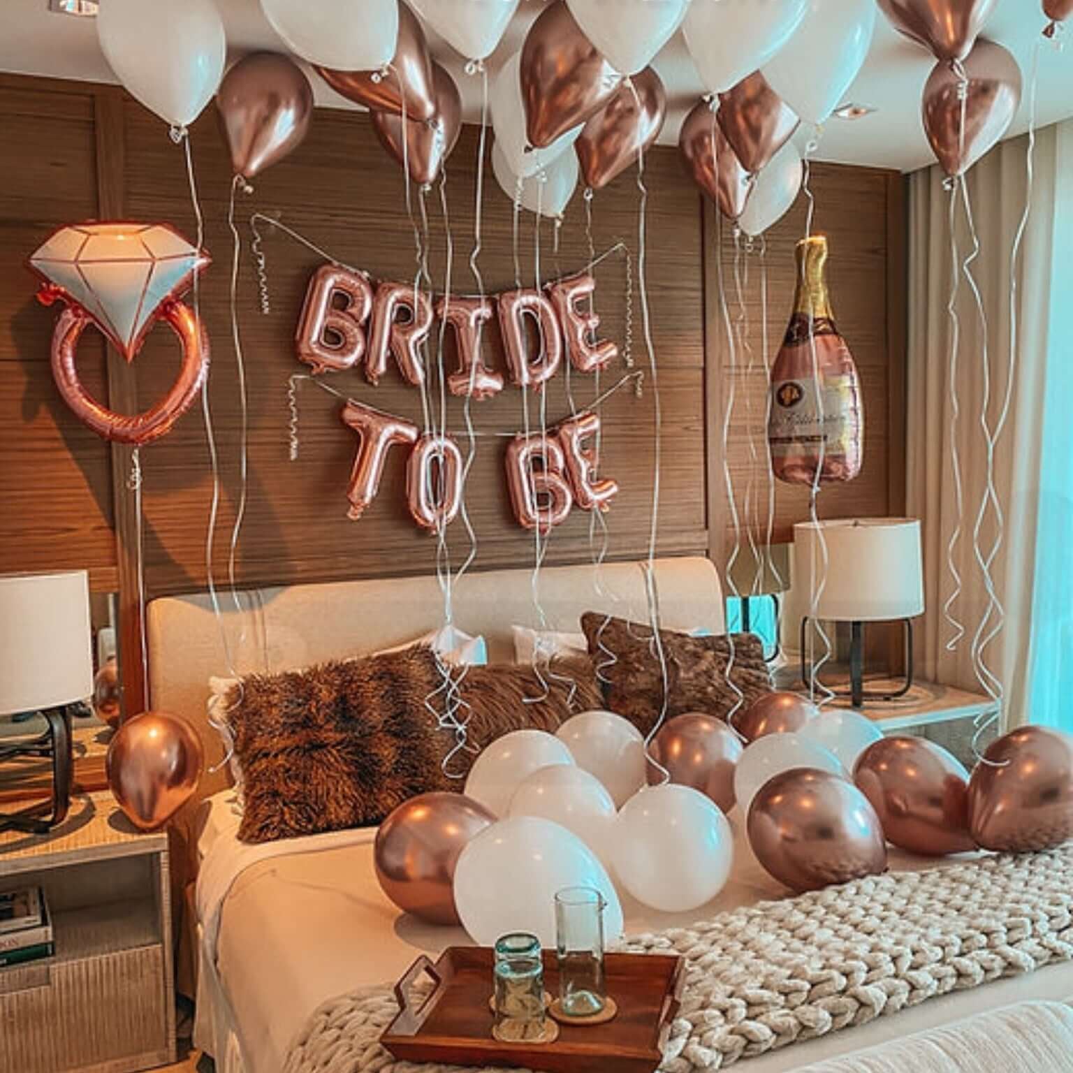 Decorated bedroom with 'Bride to Be' balloons and a diamond ring balloon.