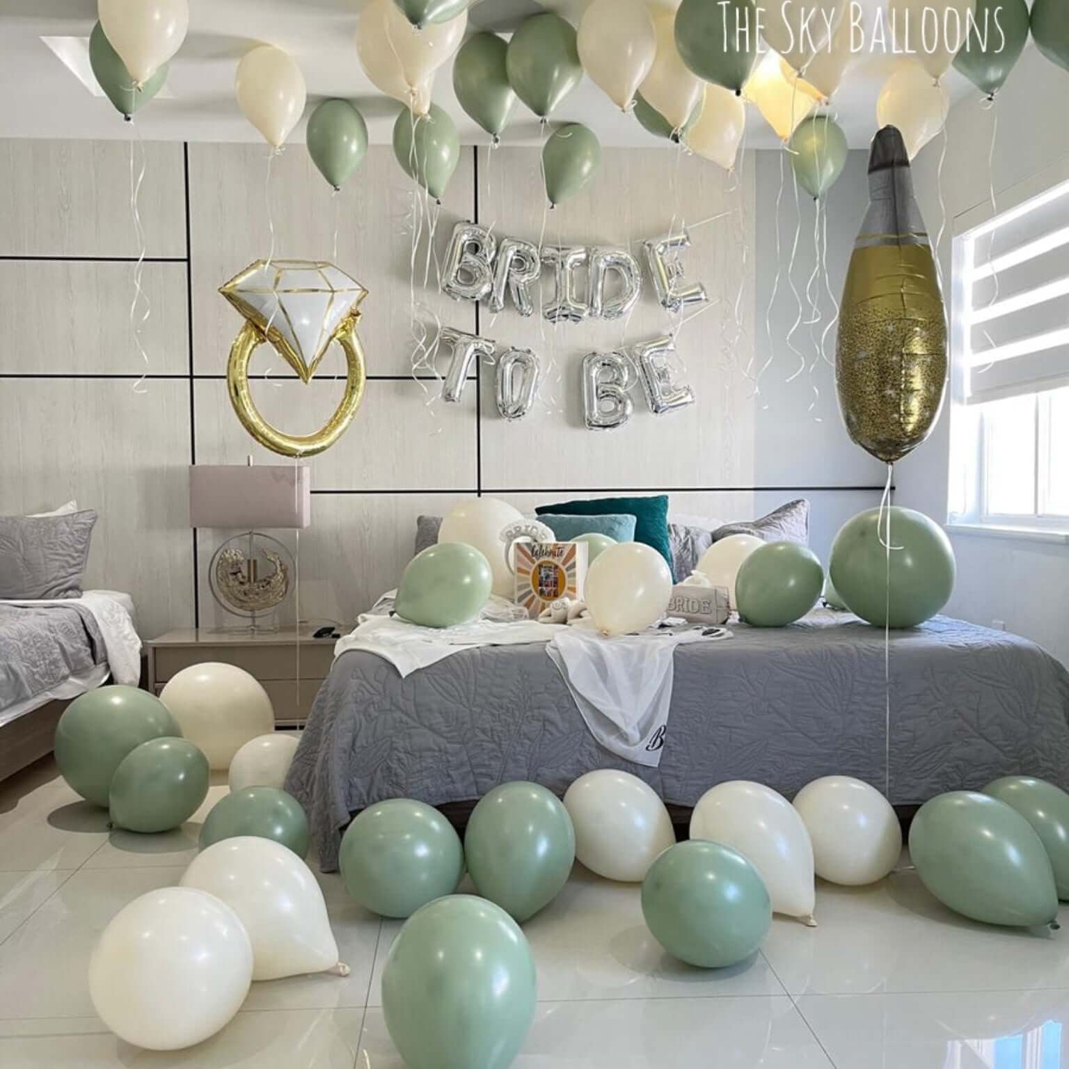 Decorated bedroom with balloons and 'Bride to be' sign, featuring The Sky Balloons brand.