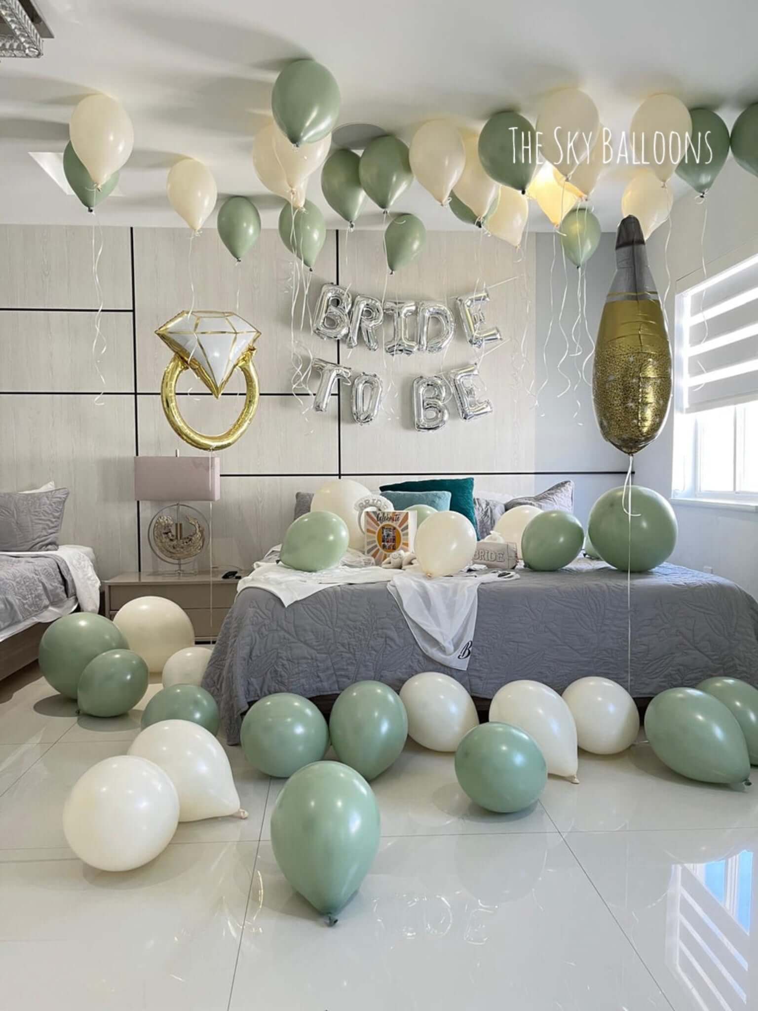 Decorated bedroom with balloons and 'Bride to be' sign, featuring The Sky Balloons brand.