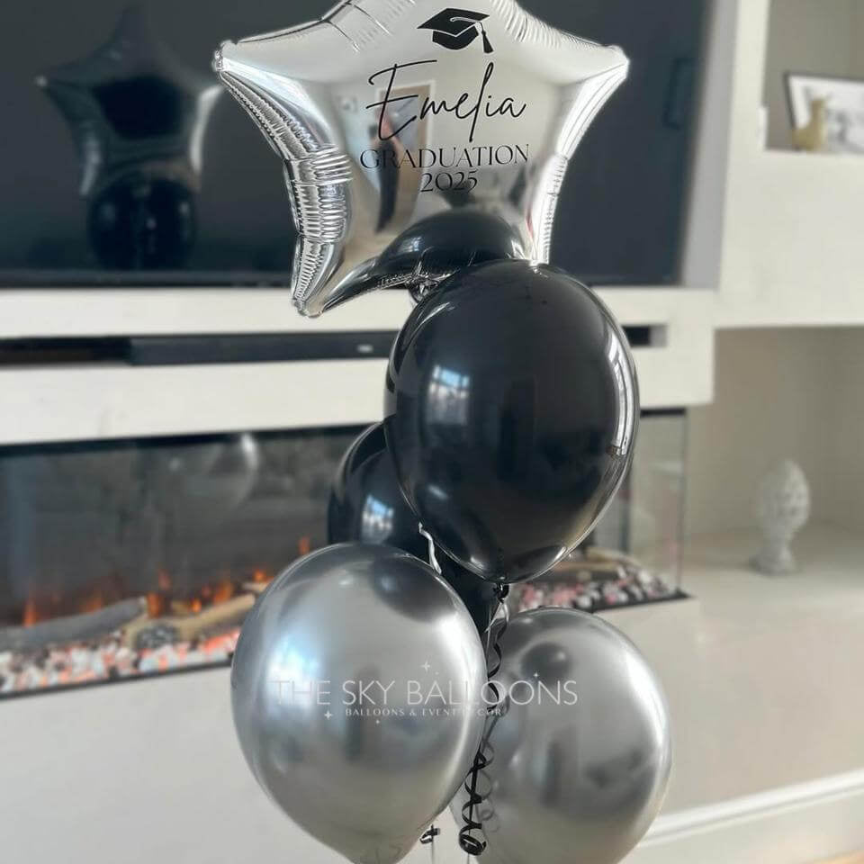 Decorative balloons with 'Evelina Graduation 2023' text in a home setting.