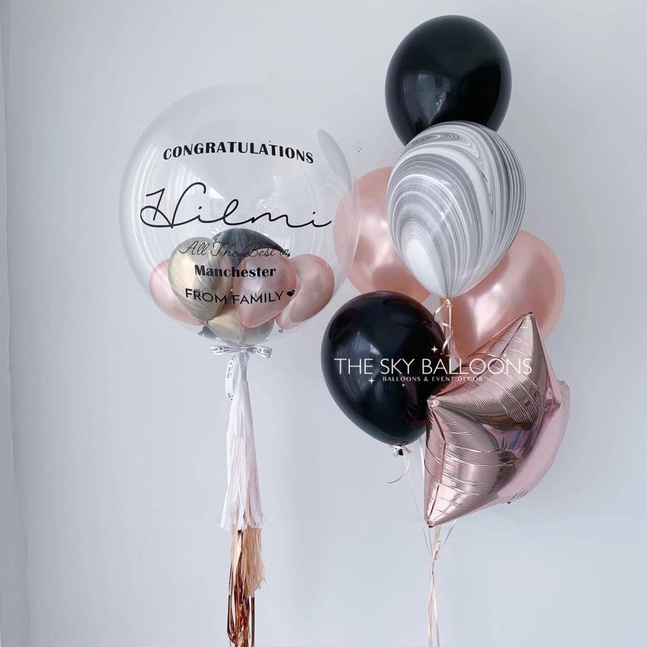 Decorative balloons with personalized text on a light gray background