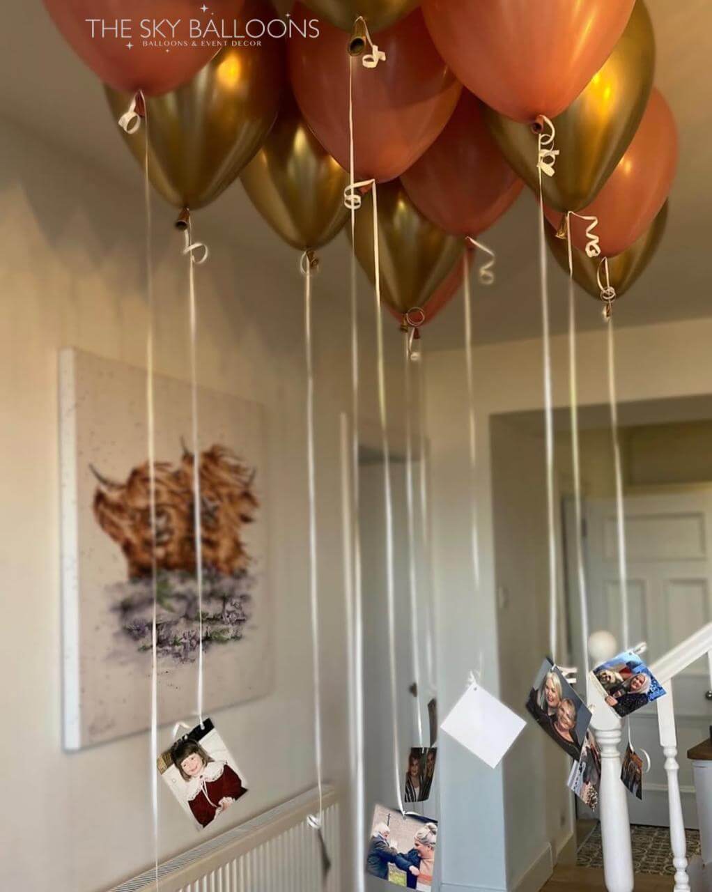 Decorative balloons with strings hanging from the ceiling in a room.