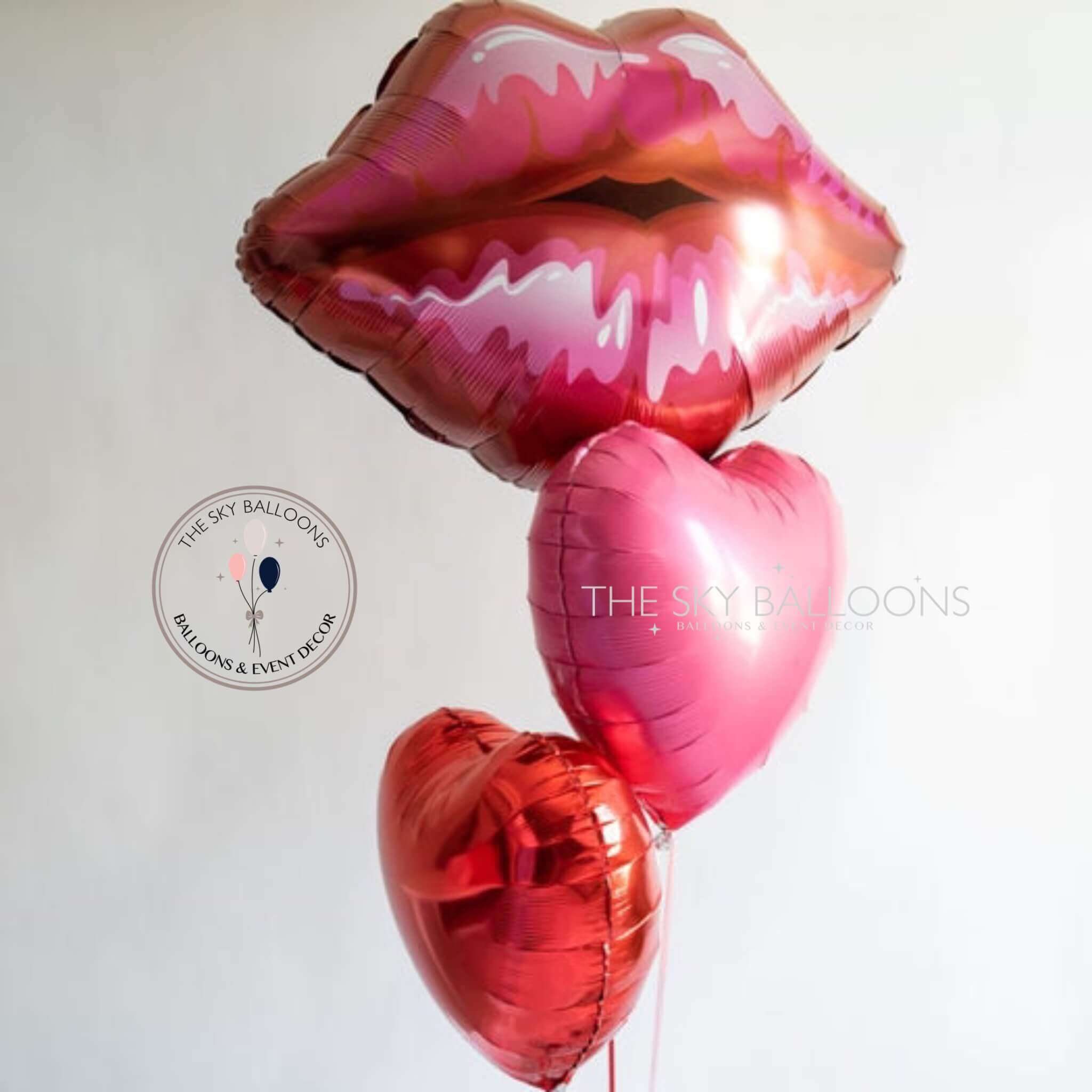 A bouquet of pink heart-shaped balloons with a lip design, released by The Sky Balloons.