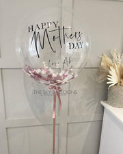 Happy Mother's Day balloon with a heart-shaped design, floating in the air, bringing joy and love.