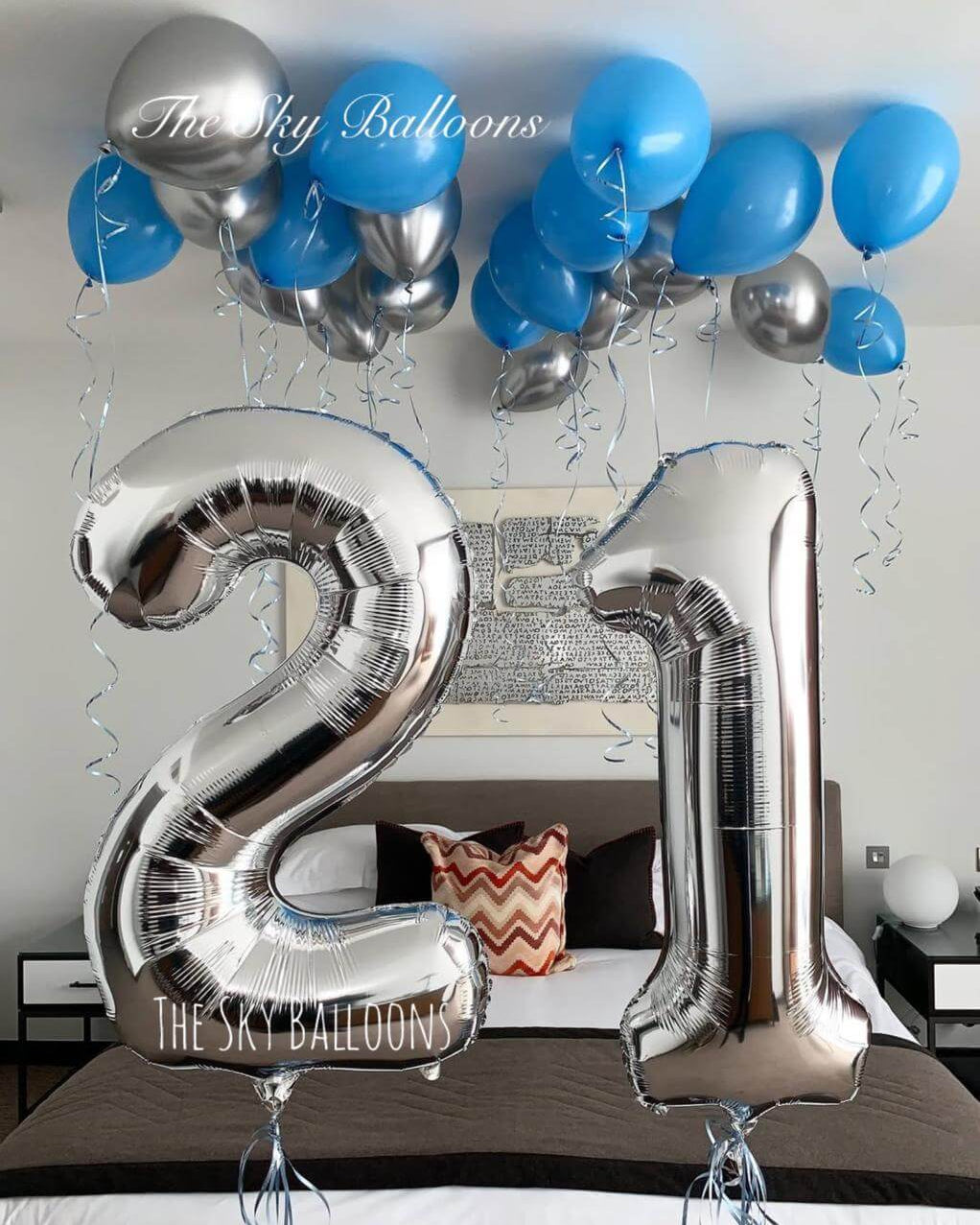 Happy 21st birthday balloon arrangement in colorful party setup