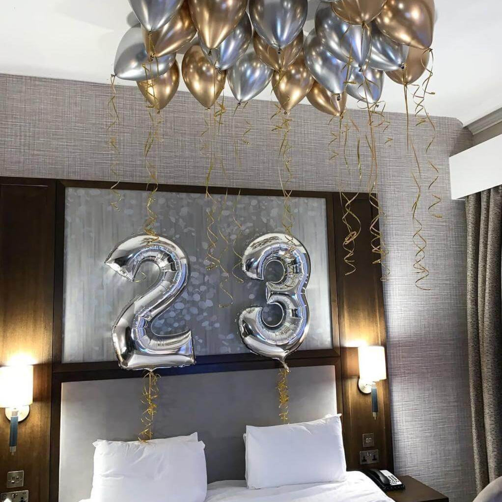 Happy 23rd birthday balloon arrangement in colorful party setup