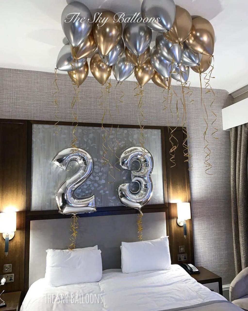 Happy 23rd birthday balloon arrangement in colorful party setup