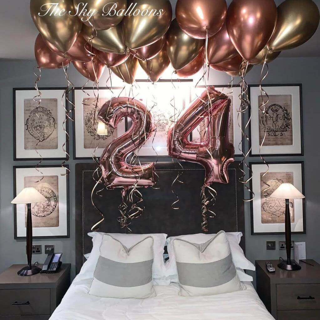 Happy 24th birthday balloon arrangement in colorful party setup