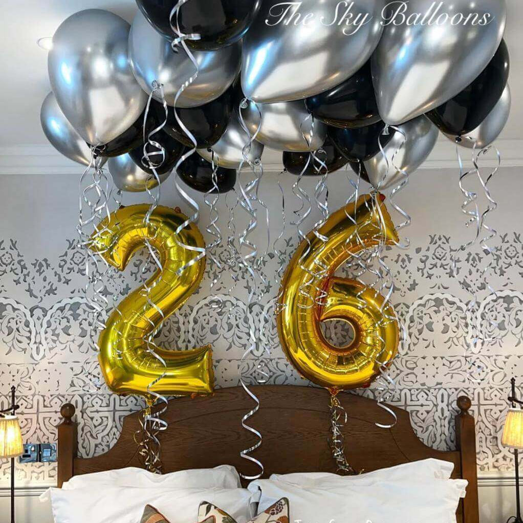 Happy 26th birthday balloon arrangement in colorful party setup