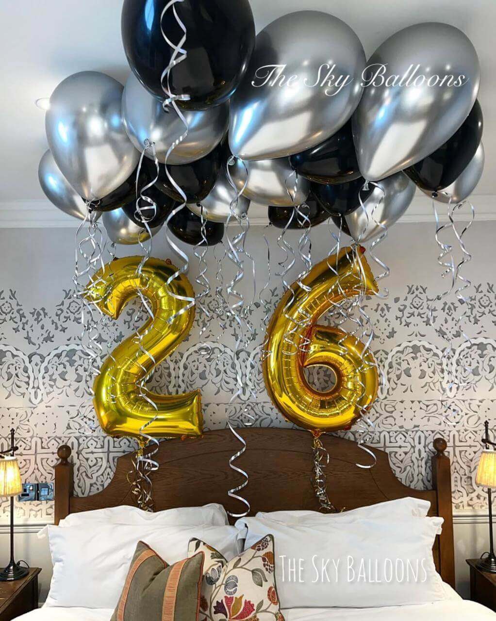 Happy 26th birthday balloon arrangement in colorful party setup