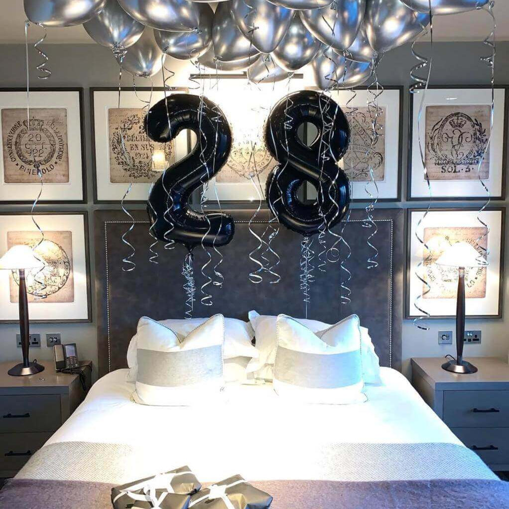 Happy 28th birthday balloon arrangement in colorful party setup