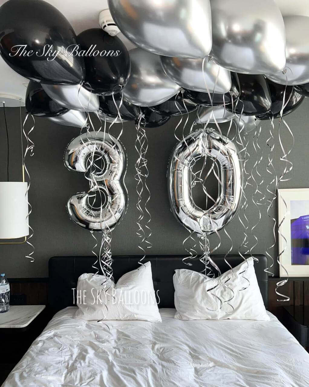 Happy 30th birthday balloon arrangement in colorful party setup