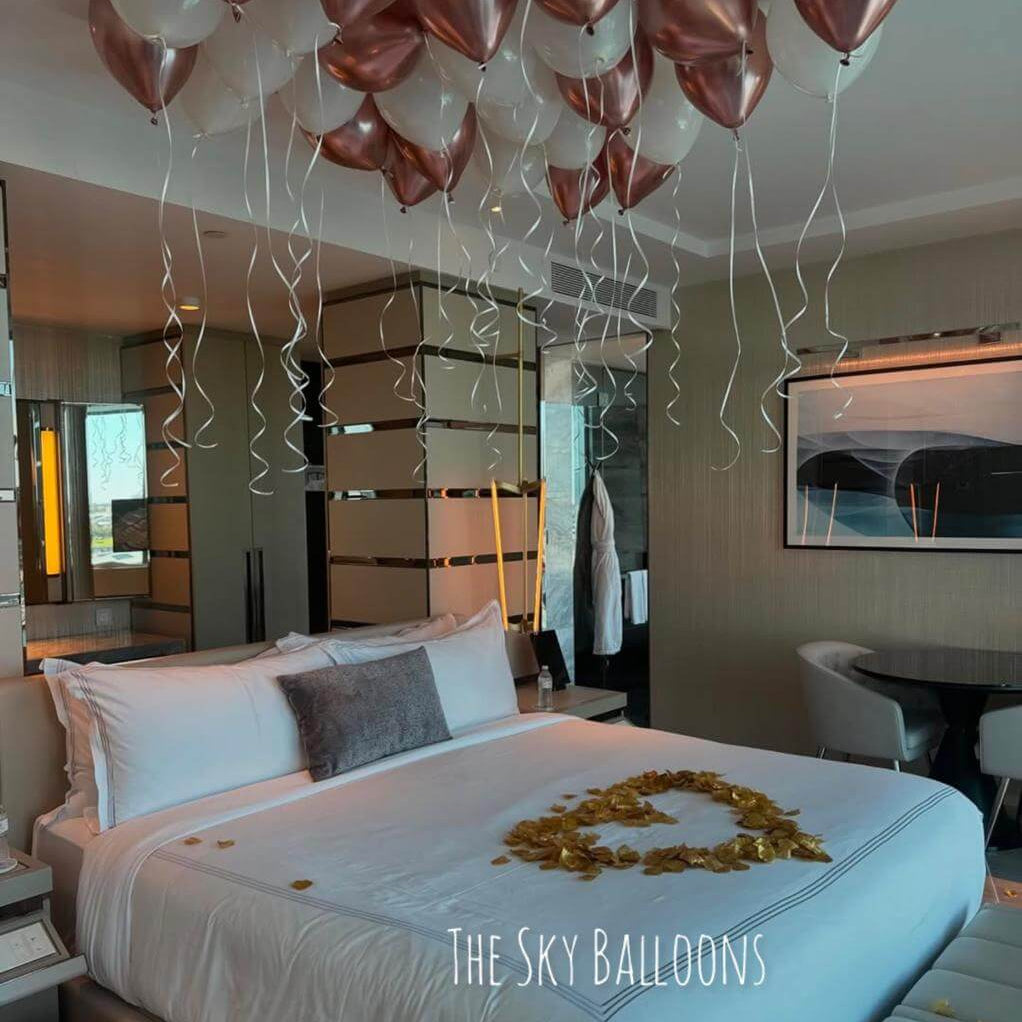 Decorative balloons in a bedroom setting with 'The Sky Balloons' branding.