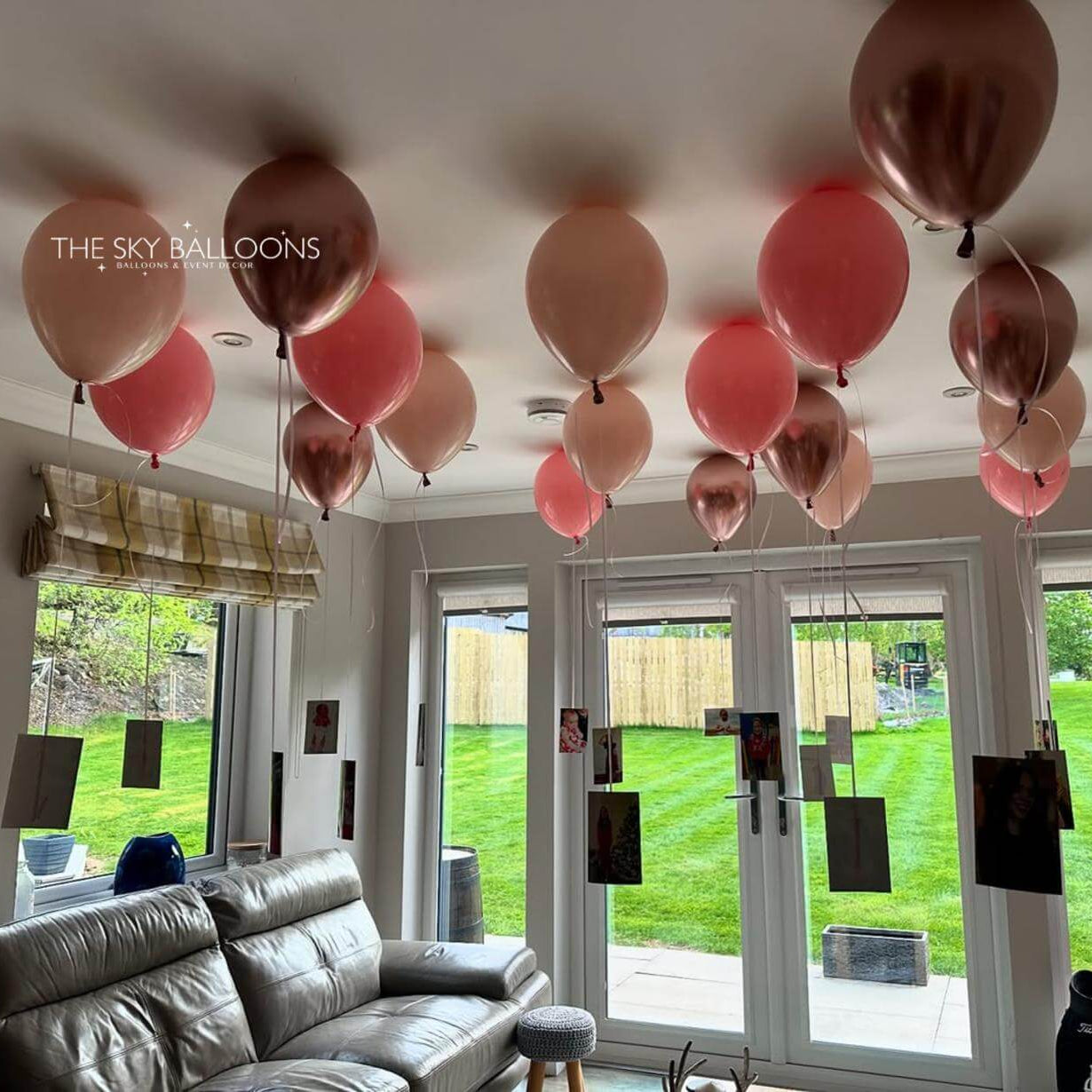 Living room with pink and gold balloons on the ceiling