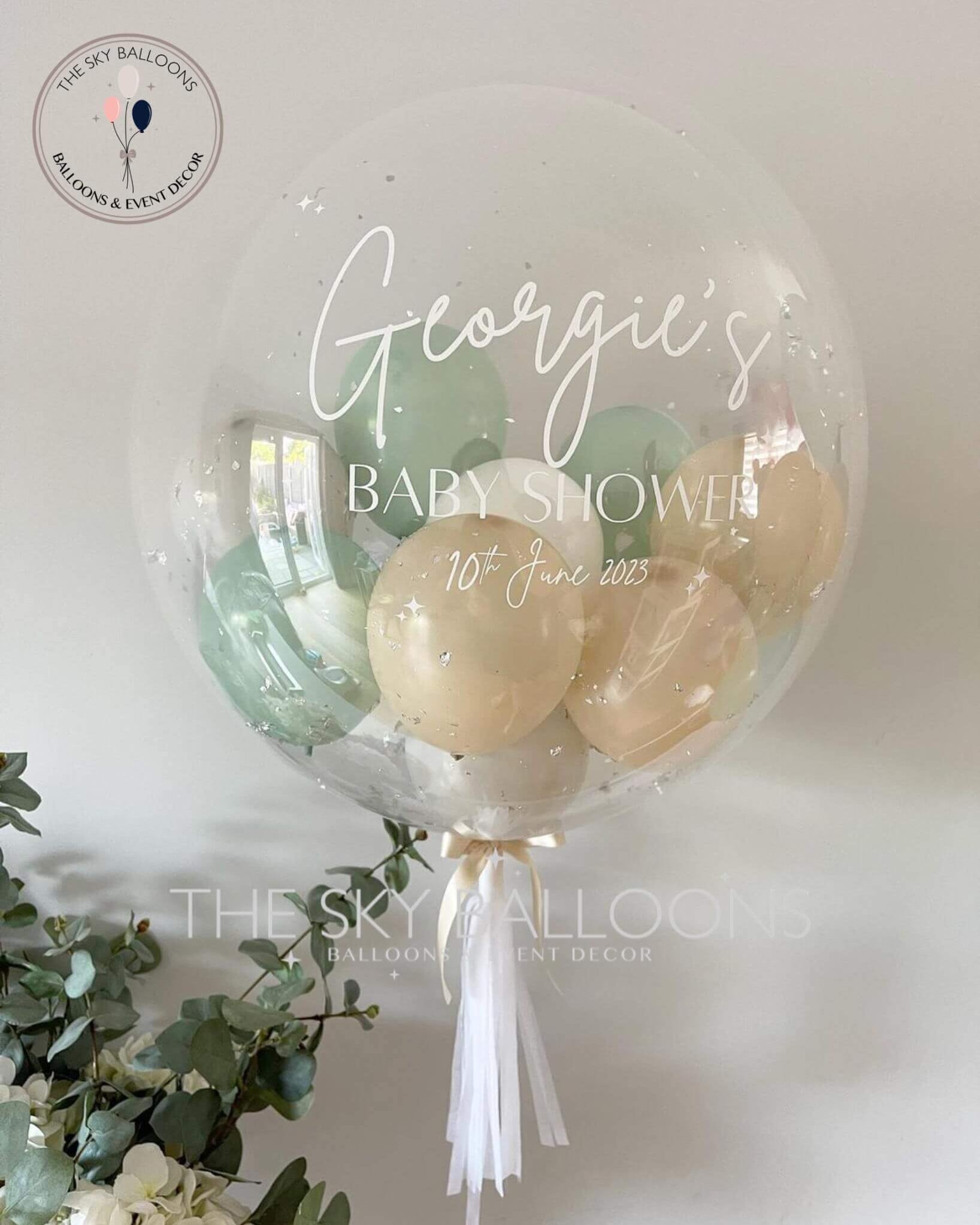 A personalized clear bubble balloon with a tassel, perfect for adding a touch of uniqueness to any celebration.