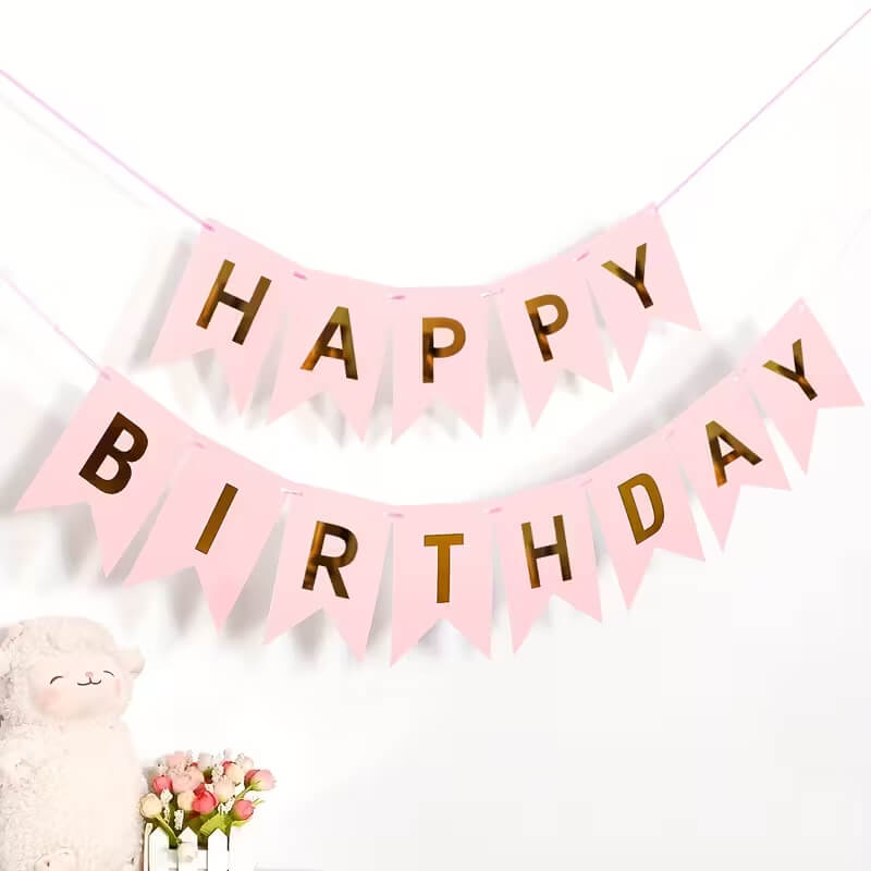 Pink 'Happy Birthday' banner with gold letters on a white background