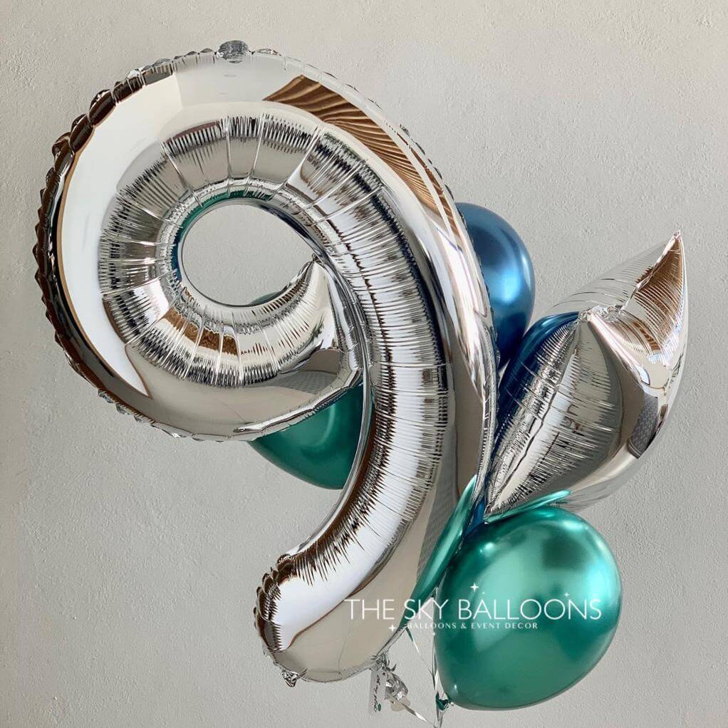 Silver and teal spiral balloon with 'The Sky Balloons' branding on a plain background