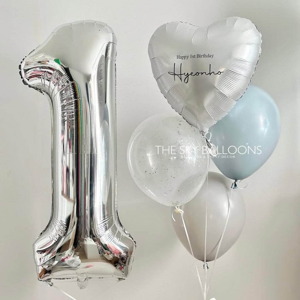 Silver number '1' balloon, heart-shaped balloon, and other balloons on a light gray background.