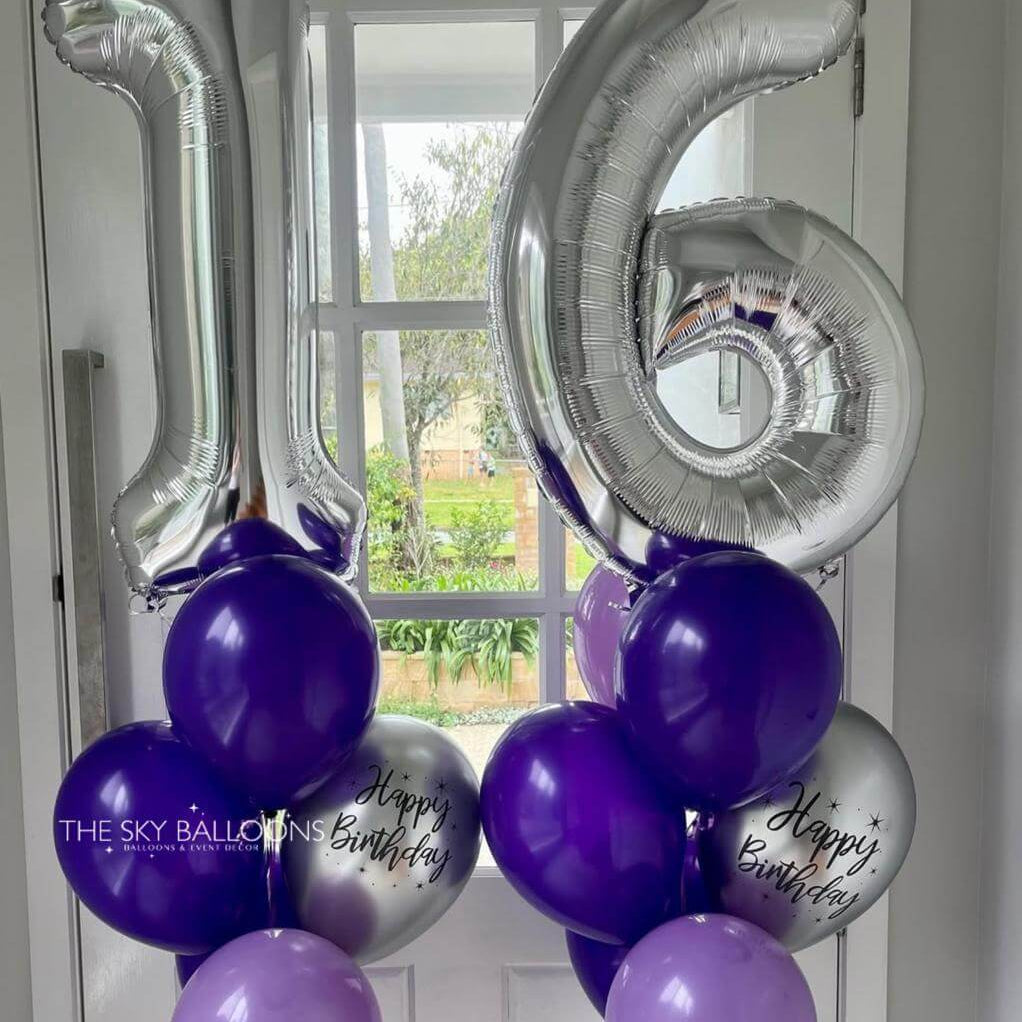 Silver number balloons spelling '16' with purple and gray balloons against a window background.