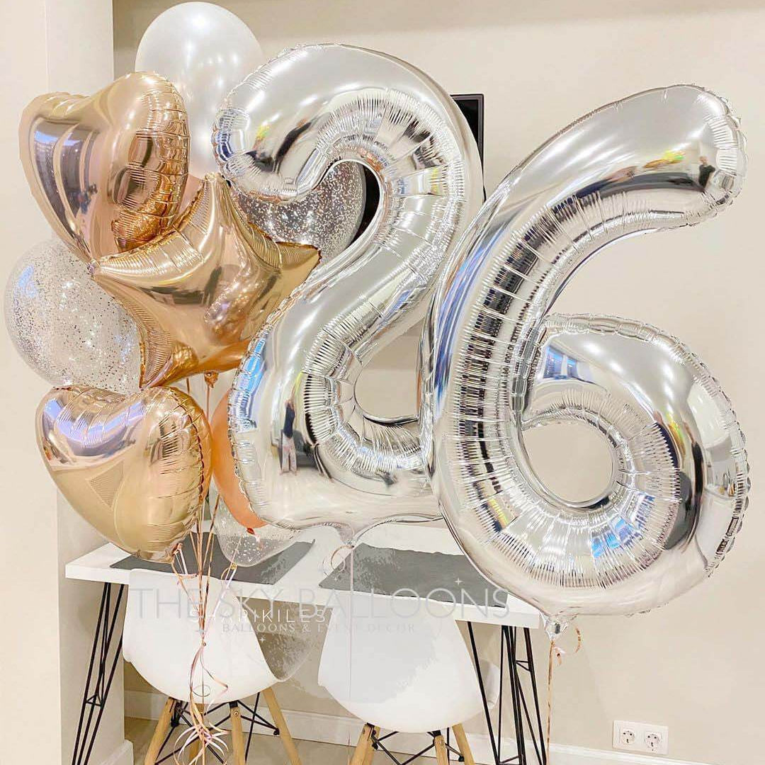 A bouquet of balloons featuring the number 26, with a mix of latex, confetti, heart, star, and number foils in silver, gold, and white colors.