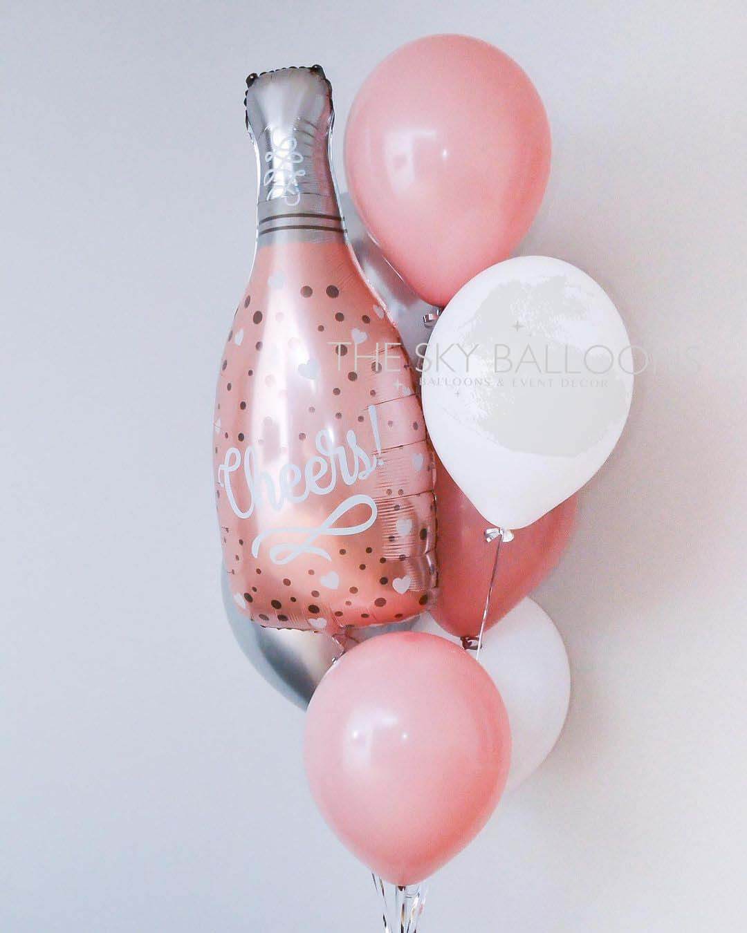 Colorful balloons arranged around a champagne bottle, perfect for celebrations and special occasions.