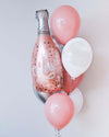  Colorful balloons arranged around a champagne bottle, perfect for celebrations and special occasions.