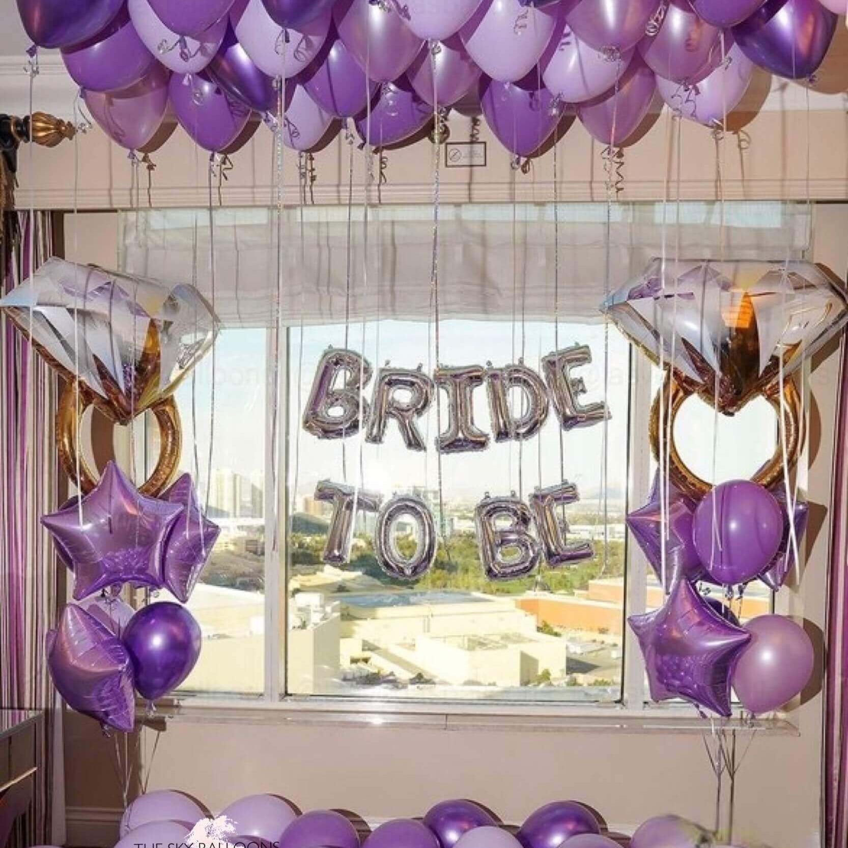 Purple balloon bouquet with bride and groom balloons, perfect for wedding celebrations.