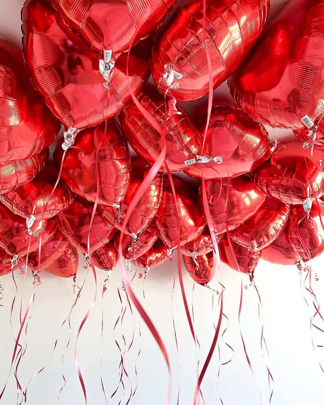 "Red heart foil balloons for Valentine's Day - romantic party decorations with ribbons