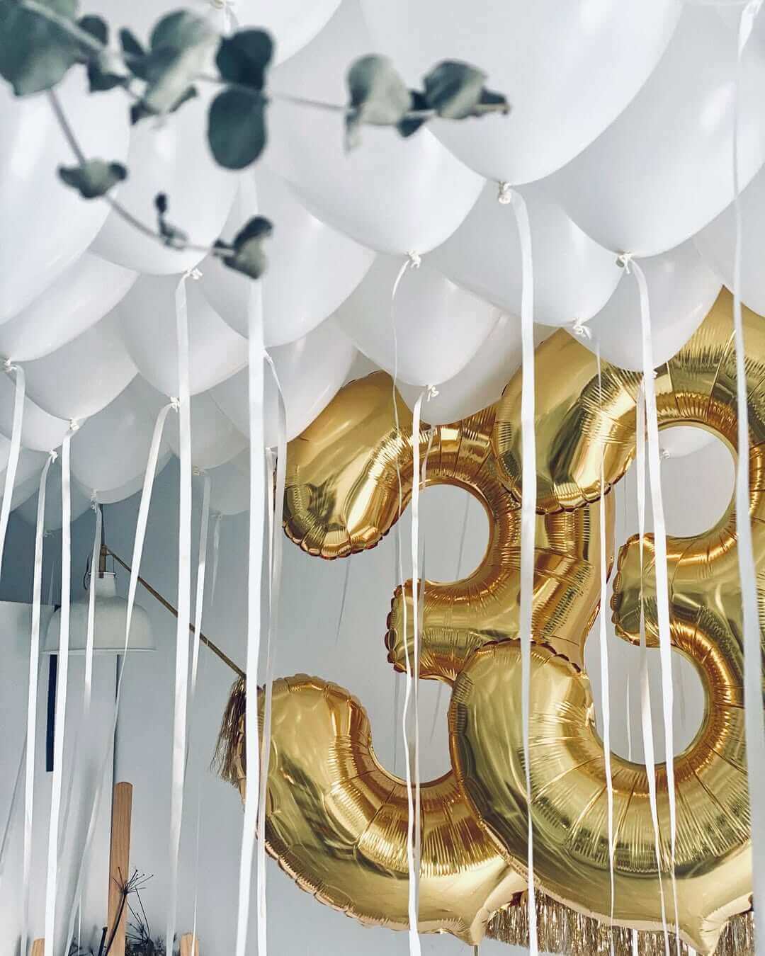 White ceiling balloons with Gold numerical balloons