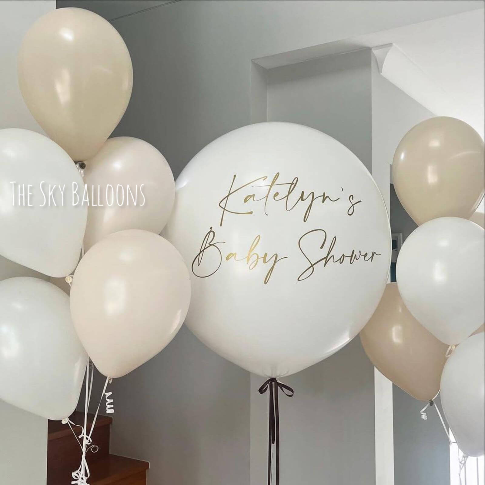 Personalized baby shower balloons in elegant cream and beige colors with custom Katelyn's Baby Shower message, delivered in Dubai