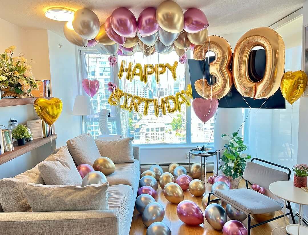 Festive bed setup with balloons and birthday decorations