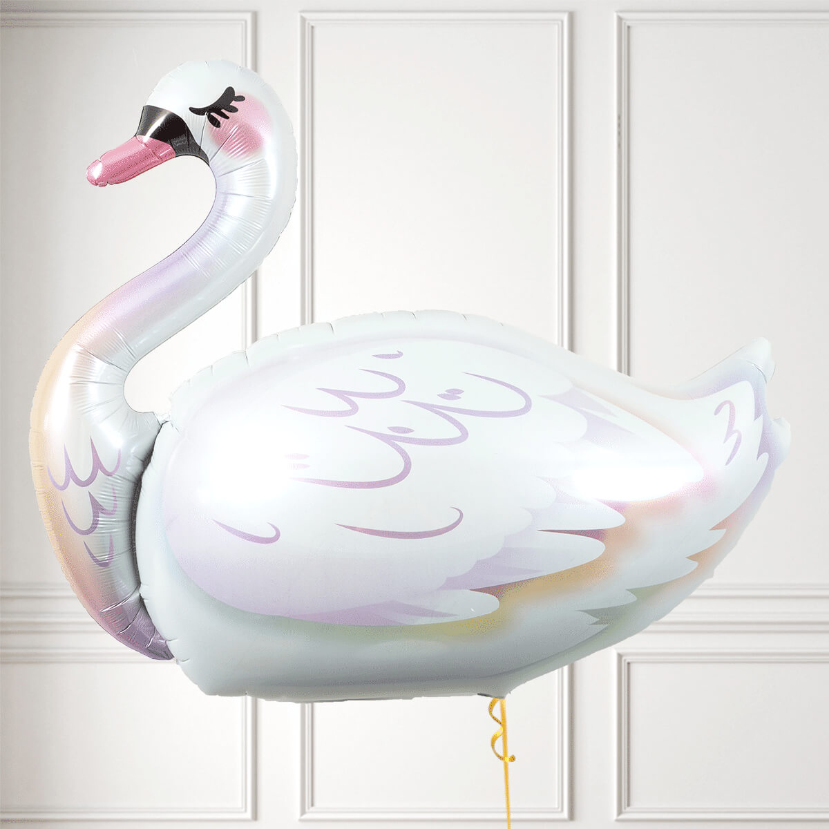Iridescent swan-shaped balloon against a white paneled wall