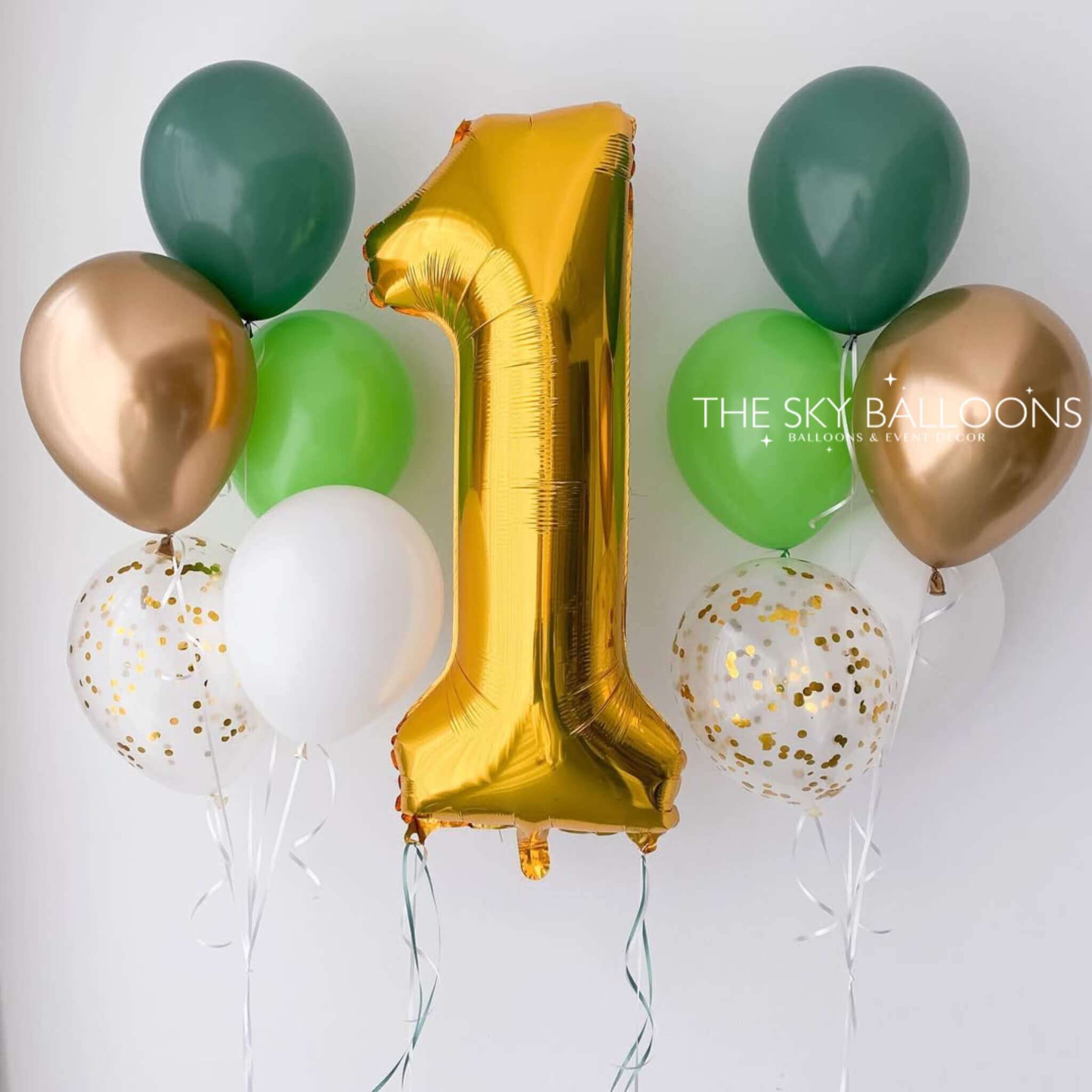 A set of balloons including one large gold number 1 balloon, surrounded by green, white, and rose gold balloons, and two with confetti patterns.