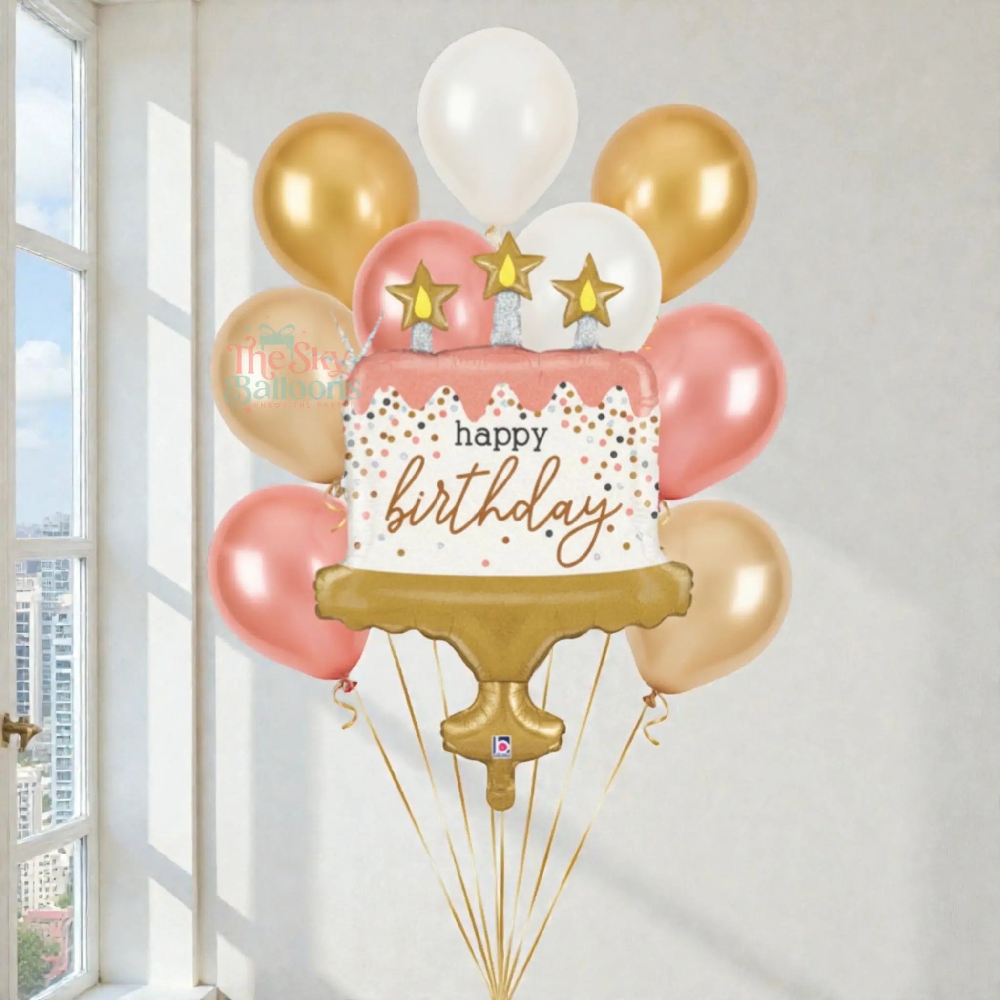 Balloon bouquet with 'happy birthday' message in a room with a window.