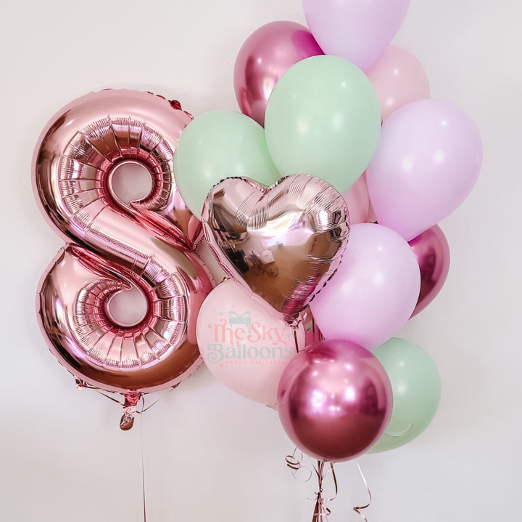 Balloon bouquet with pink number '8' and heart-shaped balloon on a white background