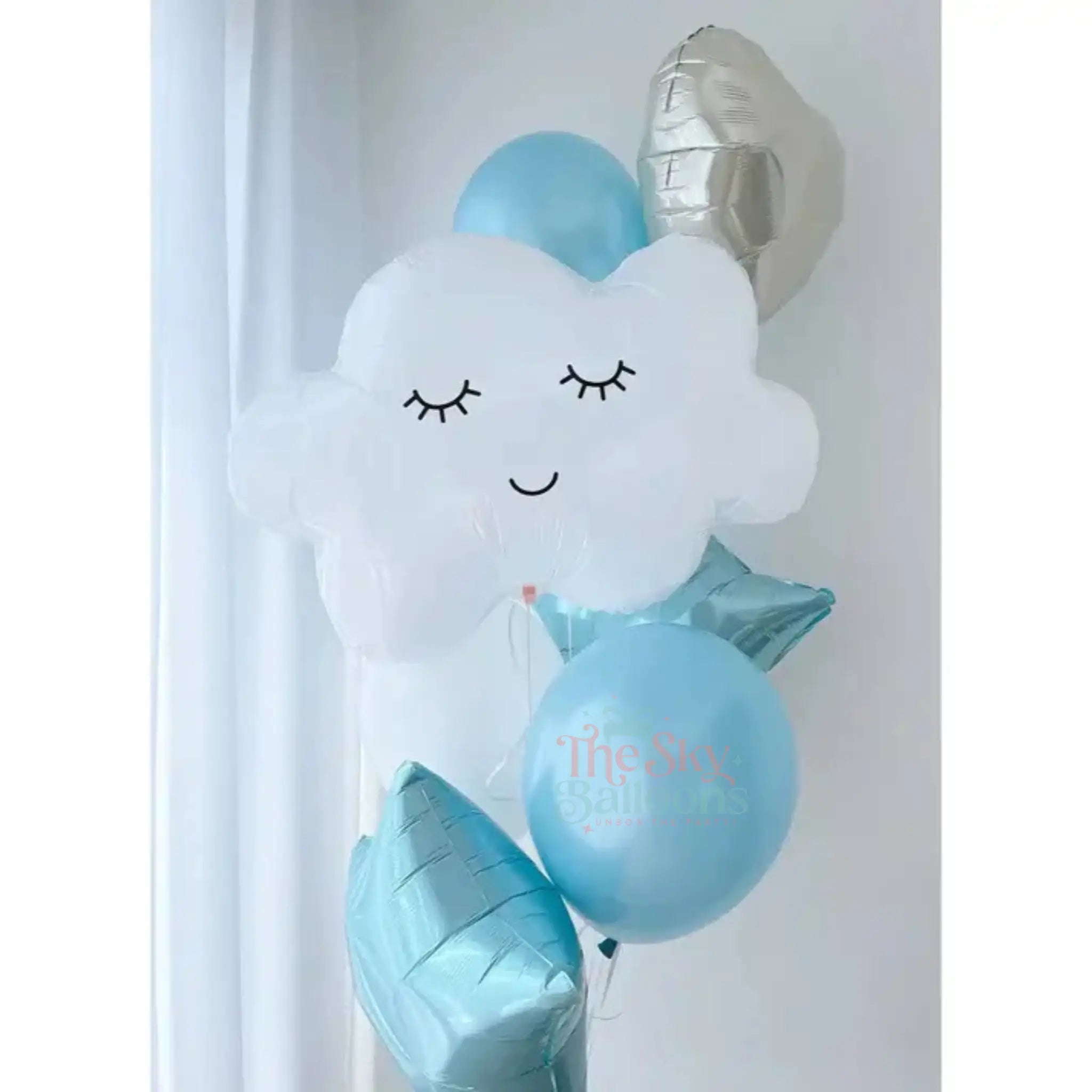 Balloon shaped like a cloud with closed eyes and a smile, held by a silver balloon, against a white background.
