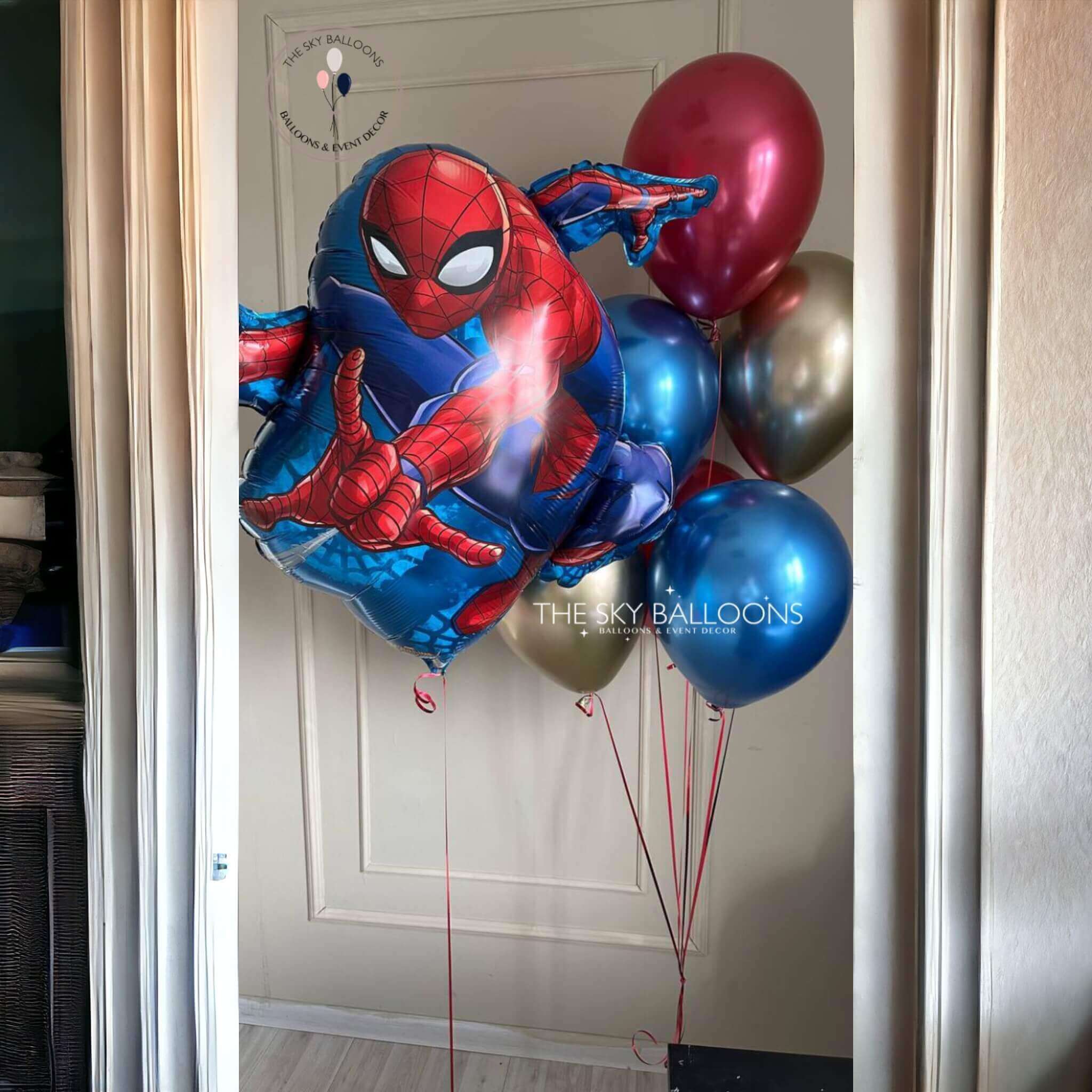 Spiderman balloon bouquet featuring red and blue balloons with Spiderman design, perfect for a superhero-themed party.