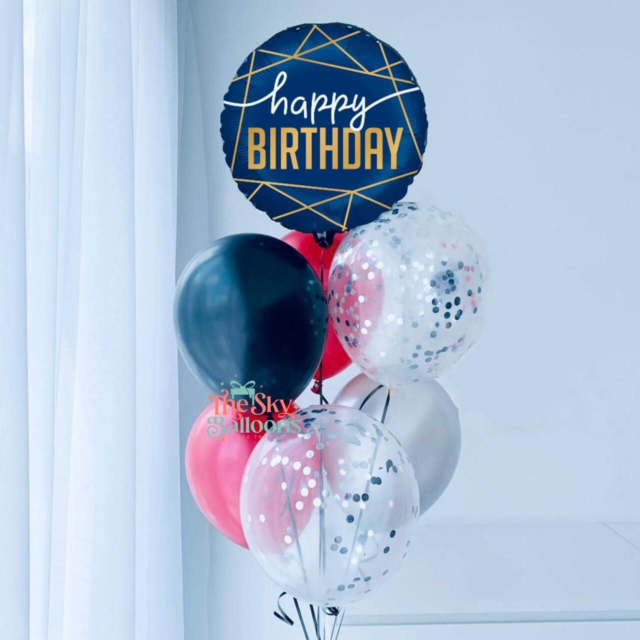 Balloon bouquet with a 'Happy Birthday' balloon against a white background