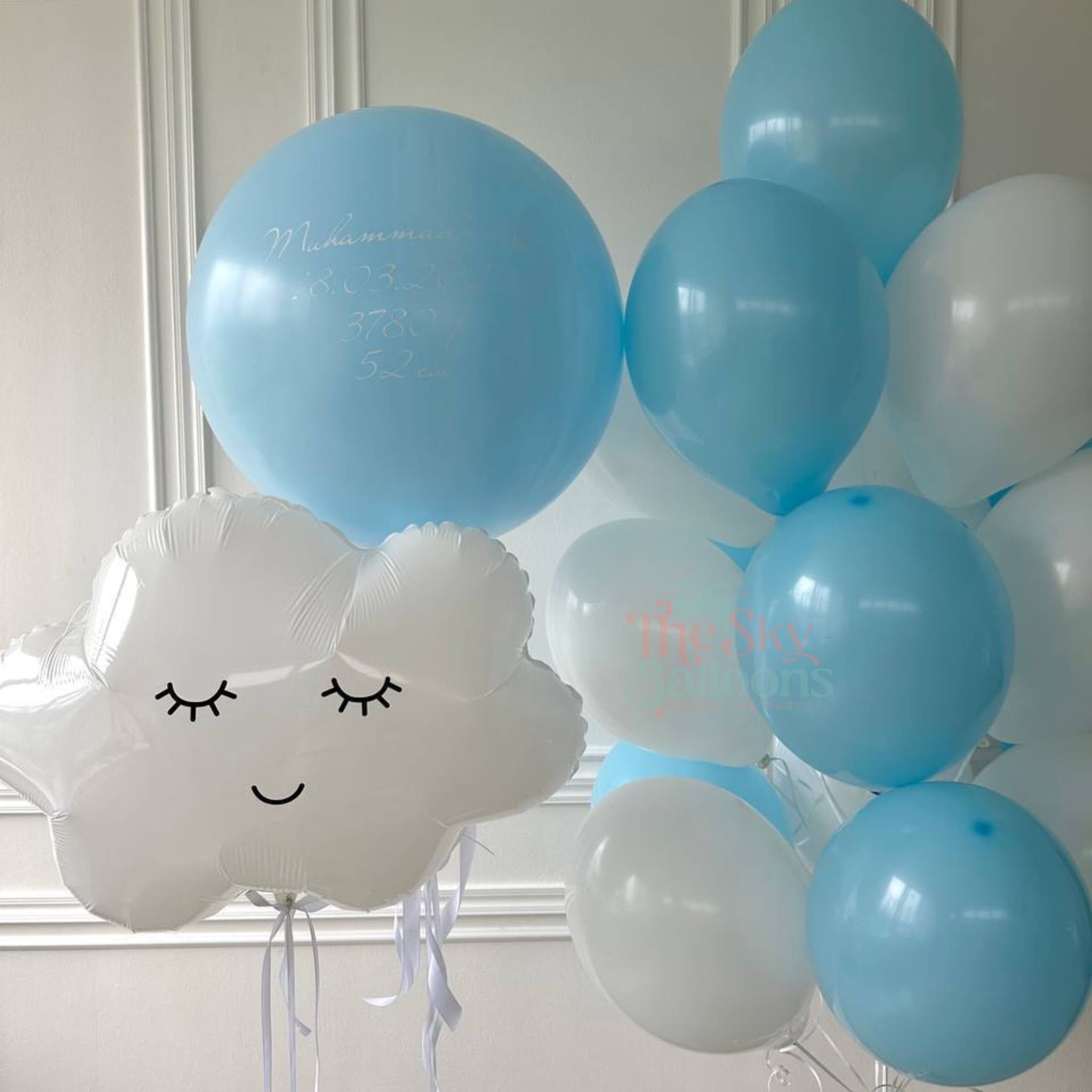 White cloud-shaped balloon with blue and white balloons in the background
