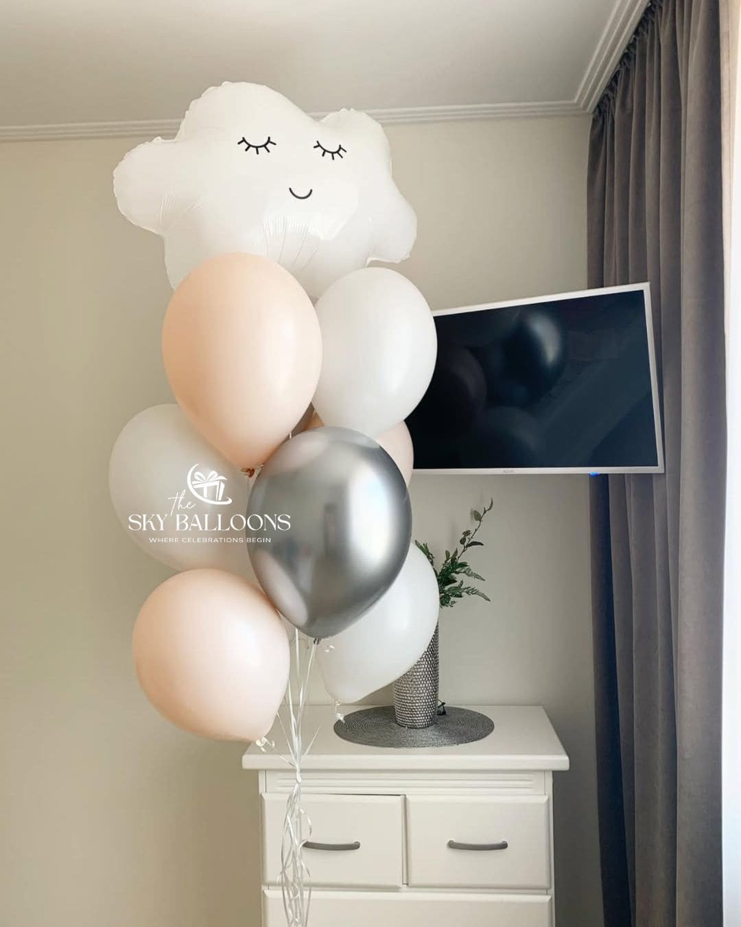 Balloon bouquet topped with a smiling white cloud foil balloon, paired with blush pink, white and metallic silver latex balloons and trailing white ribbons.