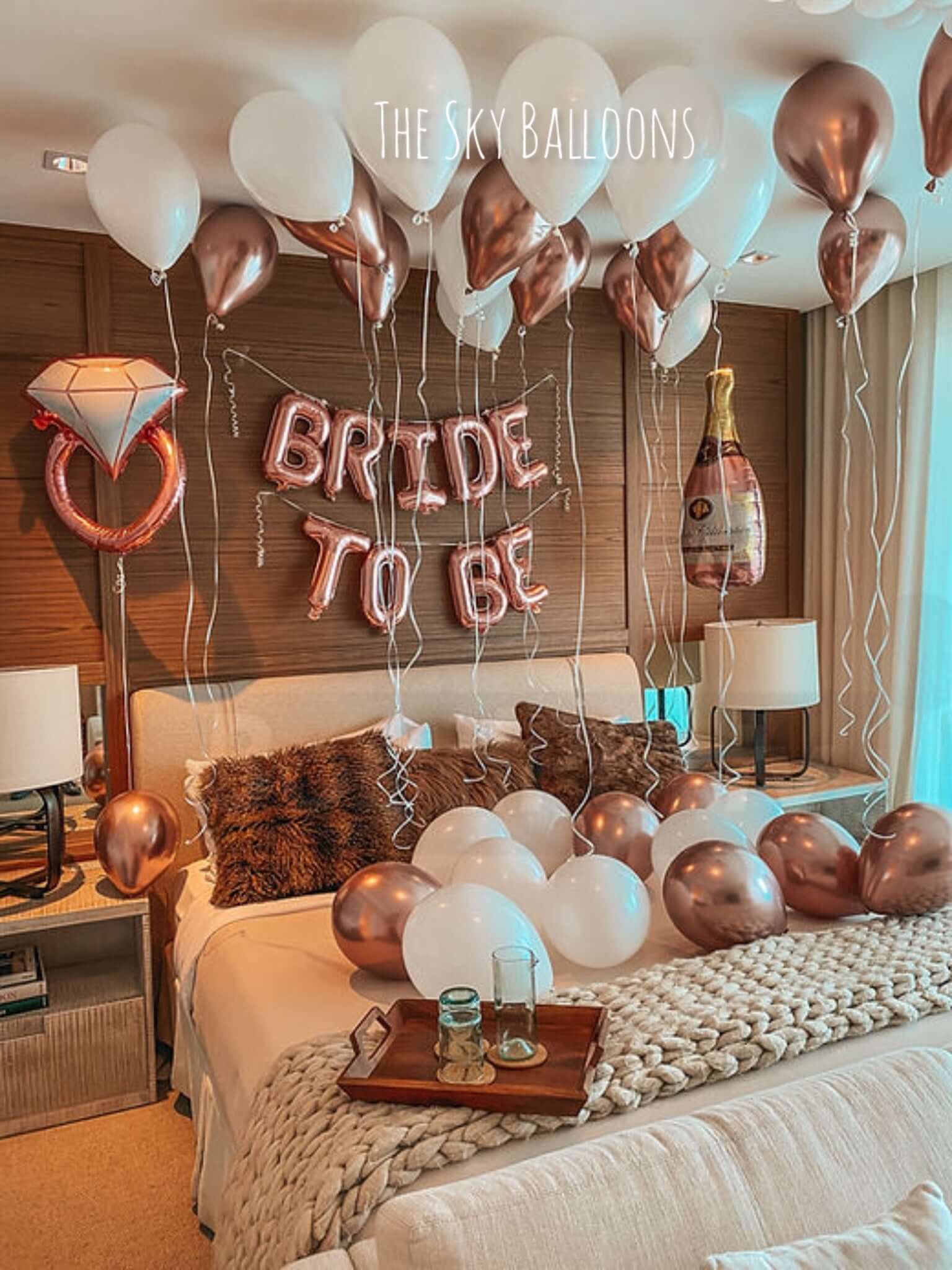 Decorated bedroom with 'Bride to Be' balloons and a diamond ring balloon.