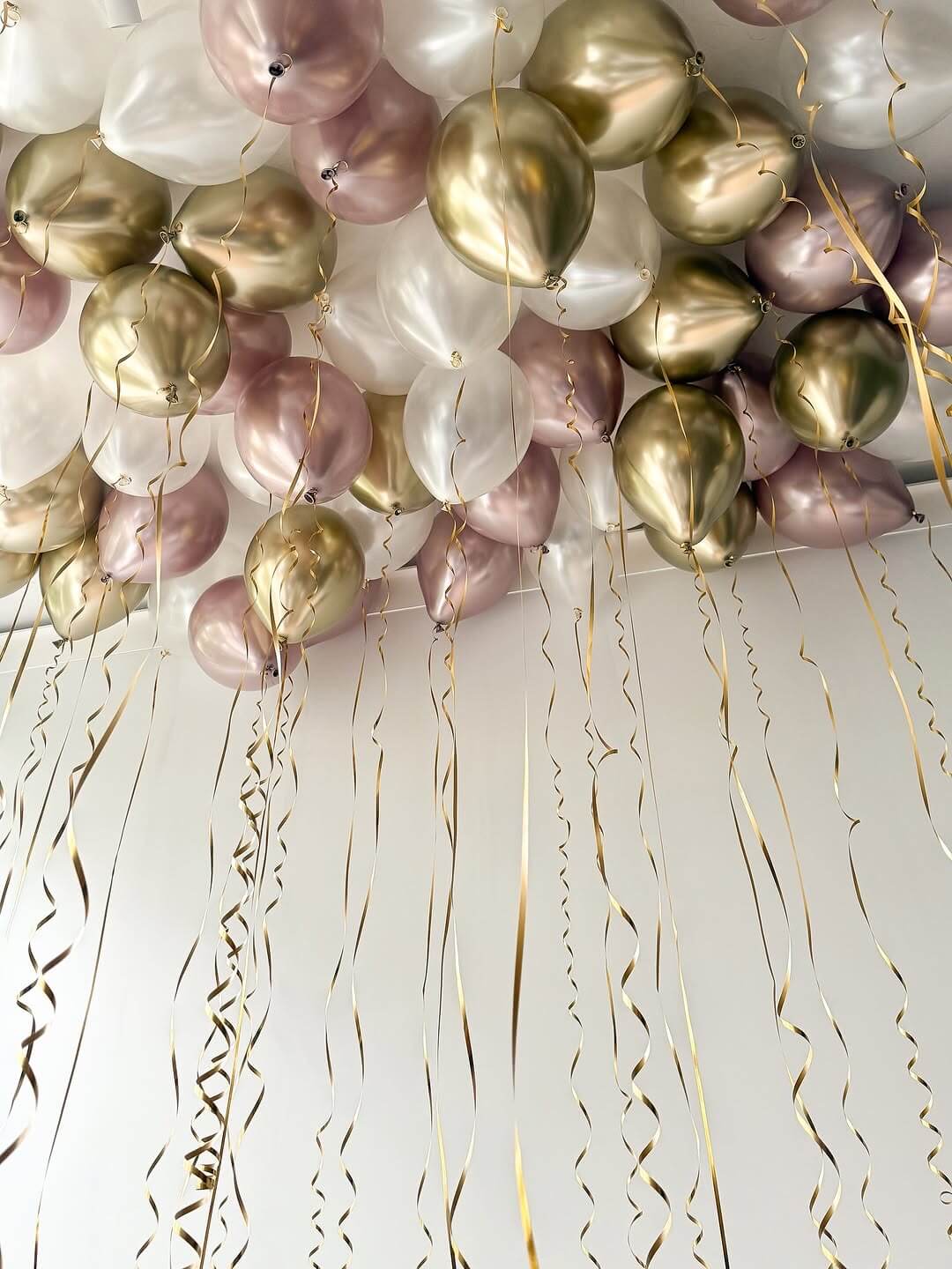 Decorative arrangement of balloons and streamers on a white background